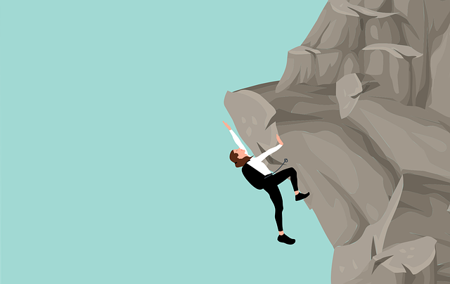 Man climbing precariously up a cliff, practicing risk management